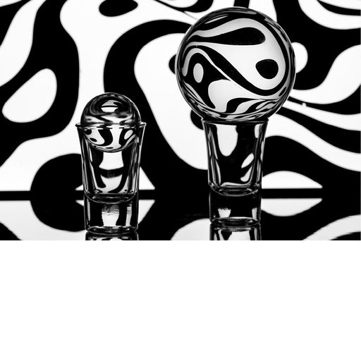 macro-opname van 2 lensballen op een spiegel met zwart-witte achtergrond