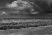 Een open landschap in dreigende stormlucht, waar ruwe textuur en zware wolken samenkomen in pure, atmosferische kracht.