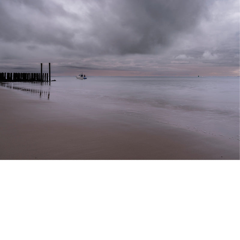 Bijzondere grijze en roze kleuren bij zonsondergang aan zee 