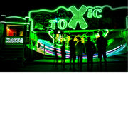 De helgroene neonlichten kleuren de Toxic attractie op de kermis.