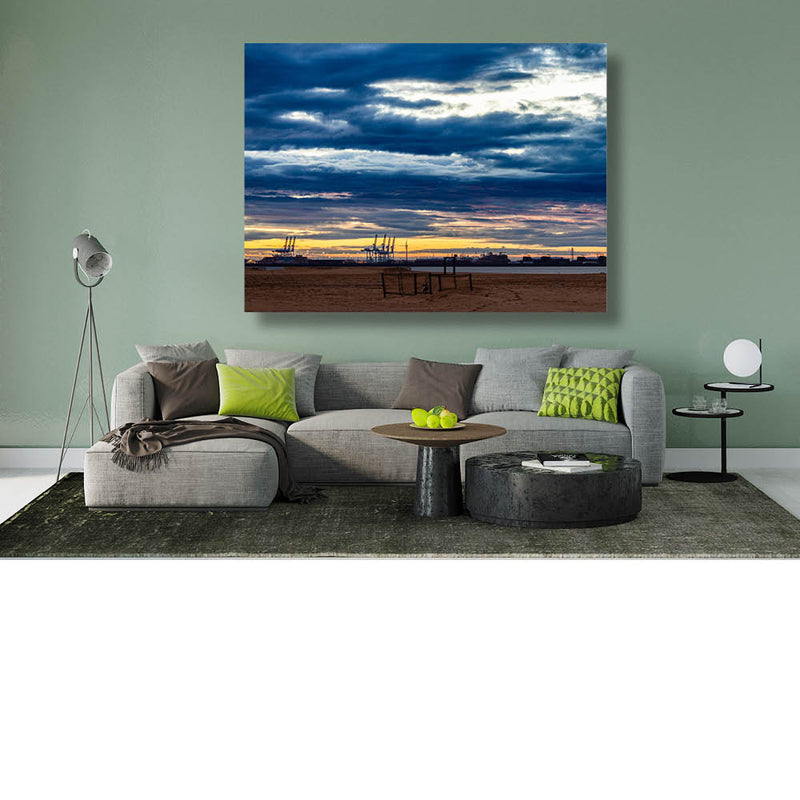 Dramatische wolken boven strand en haven